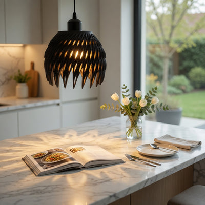 Modern kitchen with marble island, open cookbook, and decorative flowers.