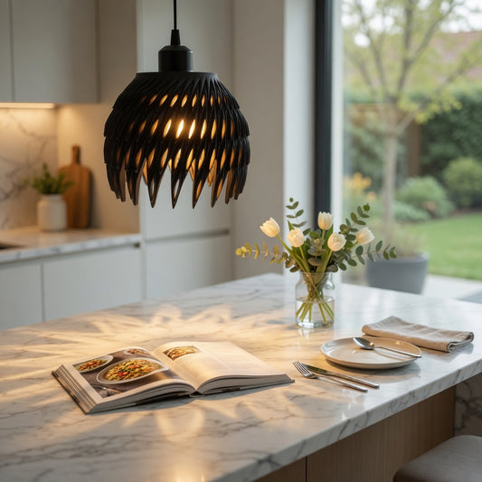 Modern kitchen with marble island, open cookbook, and decorative flowers.